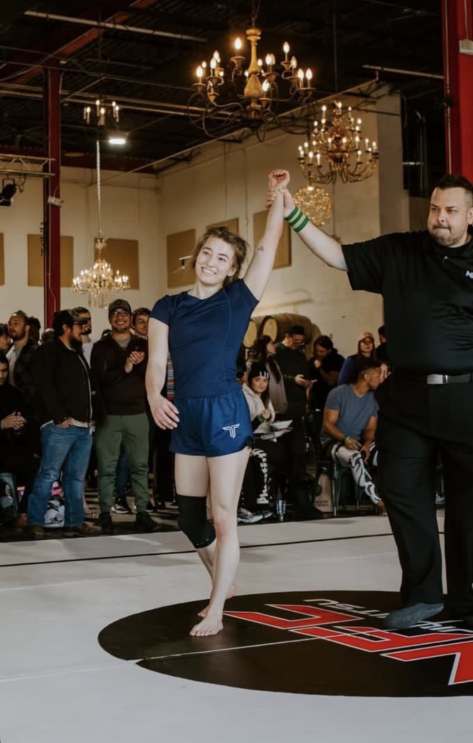 CG Bertrand with her hand raised after a match